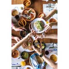 Group of friend eating mexican tacos and traditional food, snacks and people's hands over table, top view. Mexican cuisine