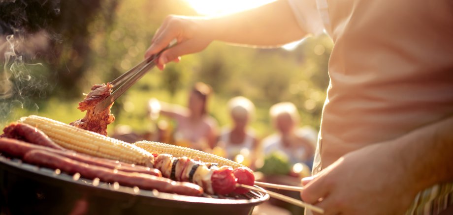 Man preparing food on garden barbecue